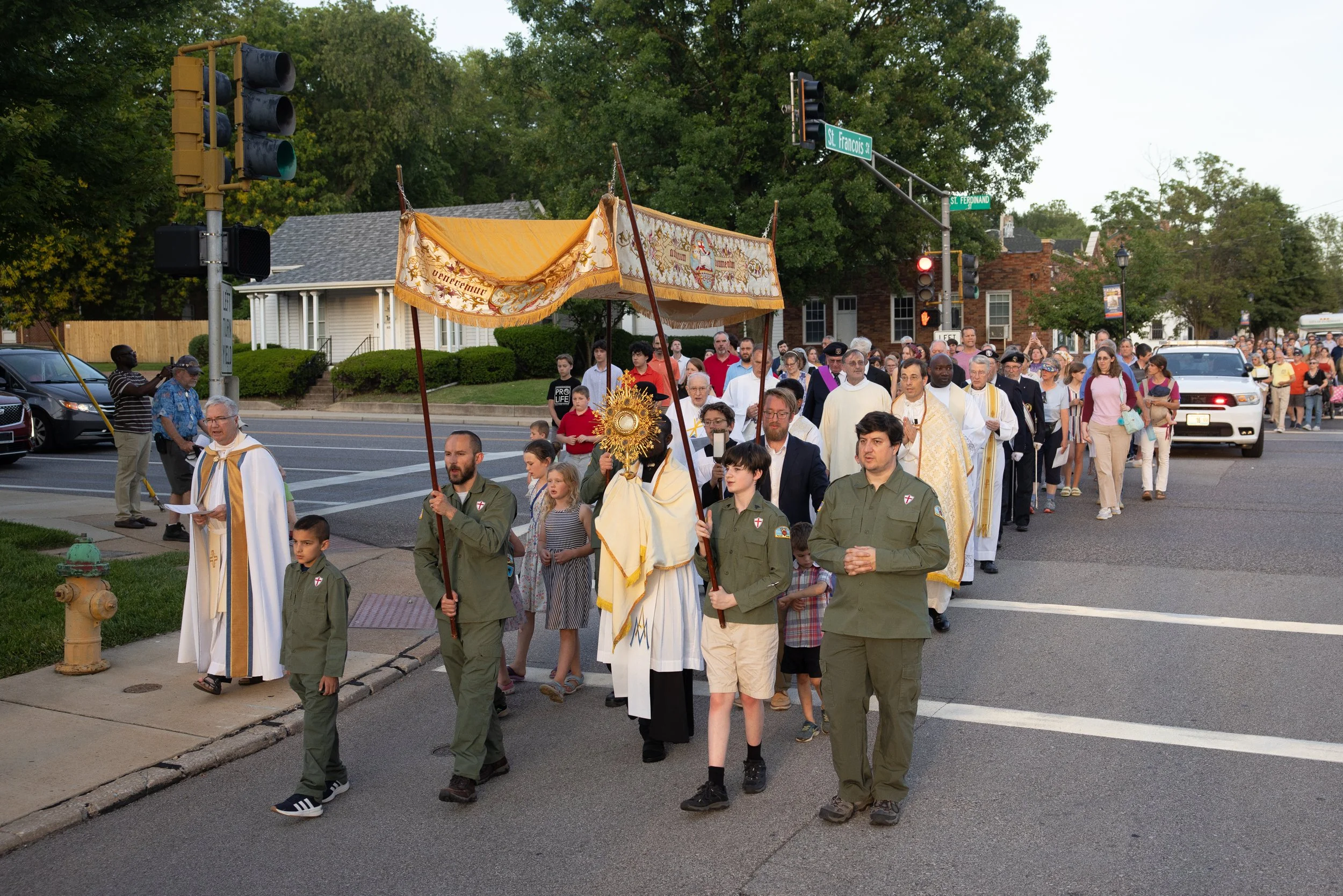 Father Peter Faimega carried the Eucharist in a monstrance during a Corpus Christi procession June 2 through Florissant, Missouri. The procession made its way from Sacred Heart Church through Florissant to the Old St. Ferdinand Shrine.