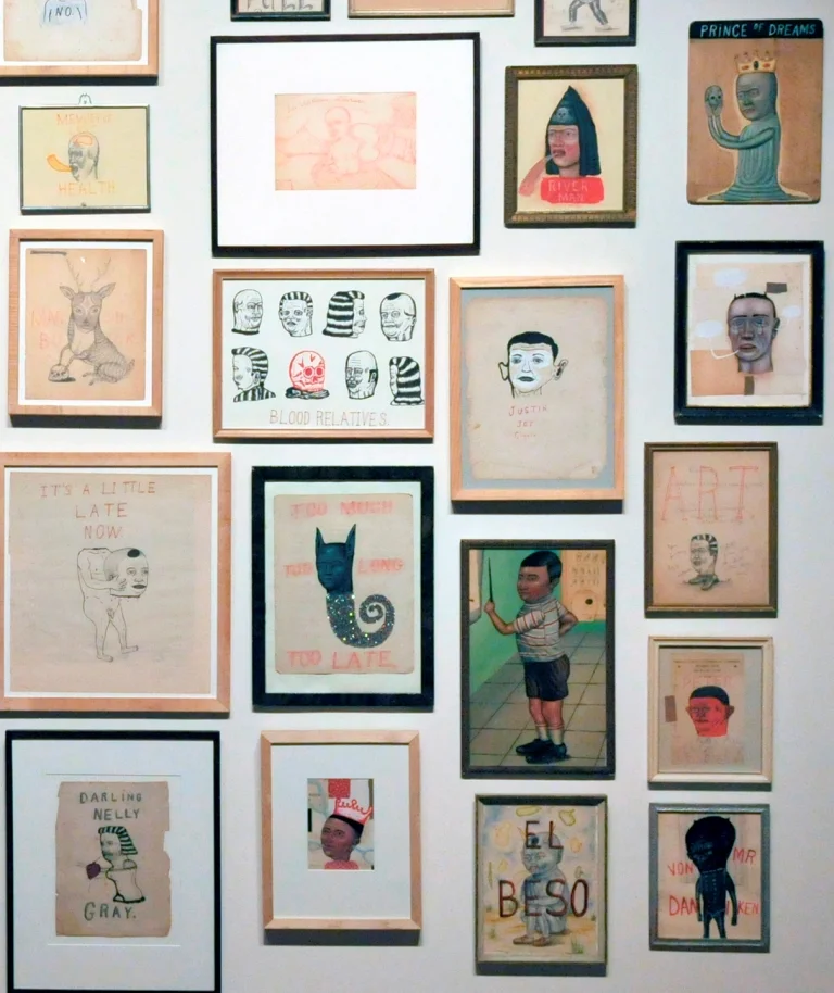 Detail of drawings and paintings on paper in vintage frames.