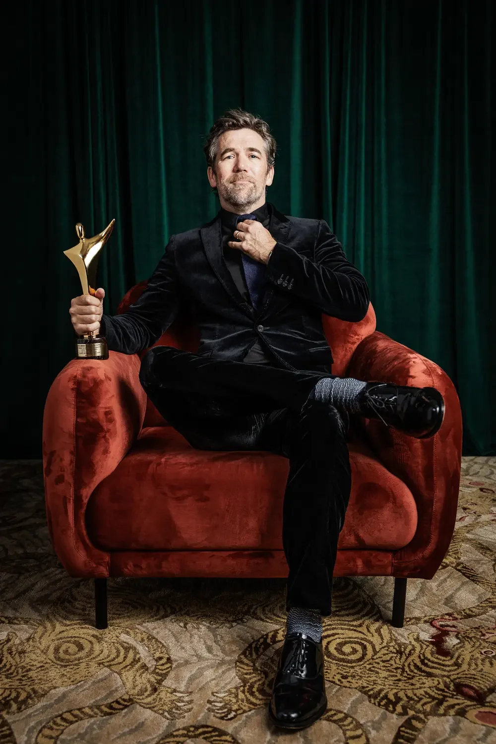 Portrait of a male actor posing with an award on the Gold Coast.