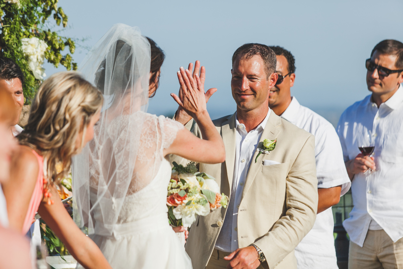 The wedding party danced down the aisle and instead of a bouquet, the bridesmaids held filled glasses of wine!