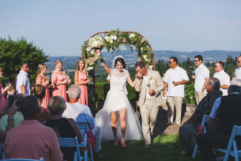 The wedding party danced down the aisle and instead of a bouquet, the bridesmaids held filled glasses of wine!