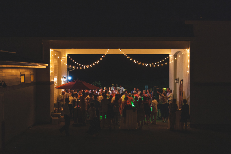 The wedding party danced down the aisle and instead of a bouquet, the bridesmaids held filled glasses of wine!