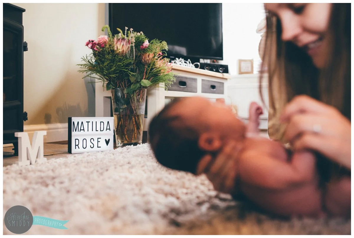 A lightbox in the family living room with their baby daughter's name on it.