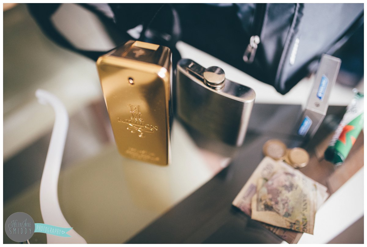 The Broom and groomsmen leave a selection of wedding items on the table such as aftershave, money, a hip-flask and cigarettes.