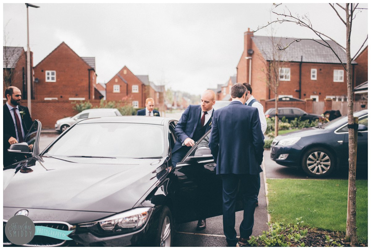 The groom gets into his Best Man's BMW to travel to his wedding in Knutsford.