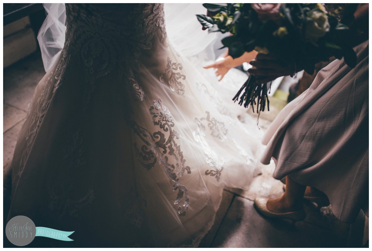 Close up of the detail of the brides lace Maggie Sottero gown.