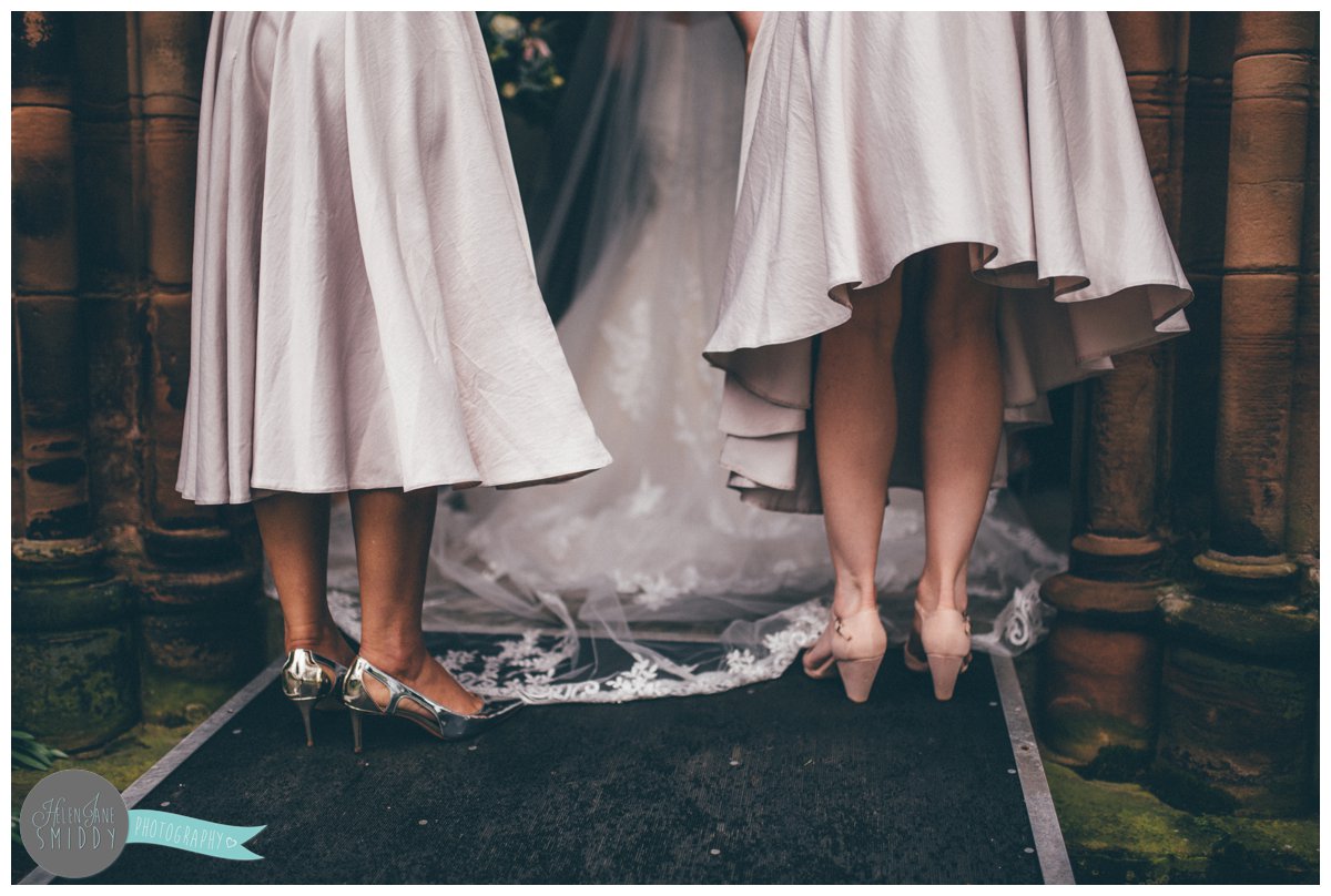 The bridesmaids stand behind the bride before the wedding ceremony.