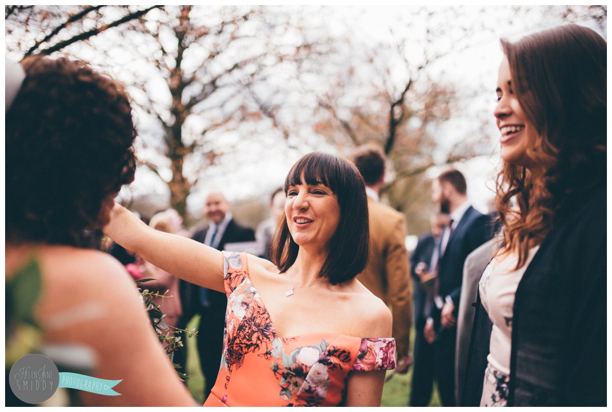 Wedding guest greets the bride with a hug.