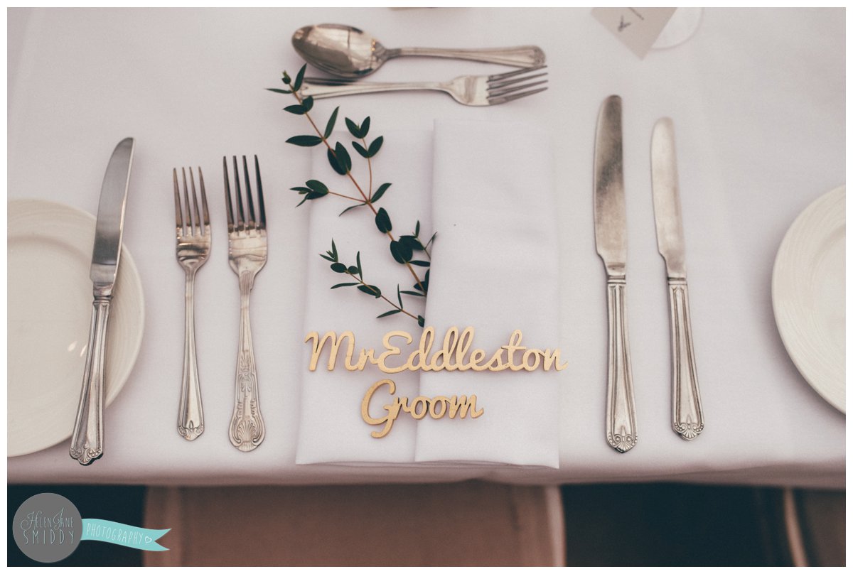 The groom's place setting was a wooden cut out of his name, sprayed golden.