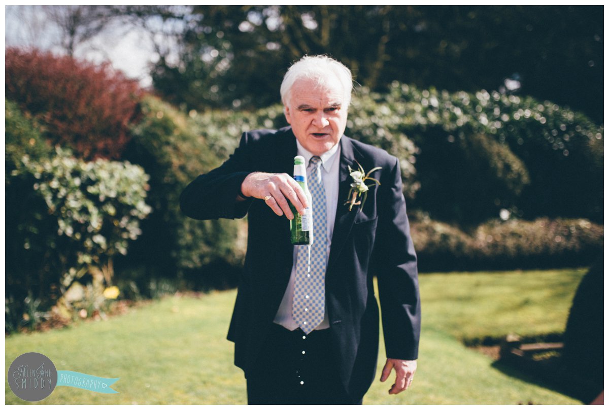 The father of the groom has a beer to celebrate and spills it!