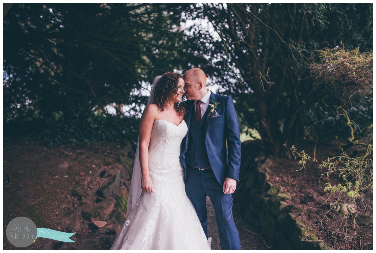 The bride and groom laugh with each other at Mere Court Hotel whilst having their photographs taken.