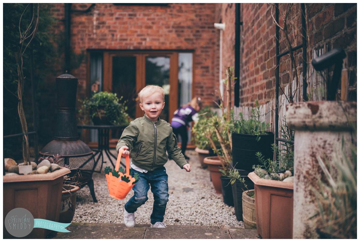 Little boy runs through the garden to find more Easter Eggs.