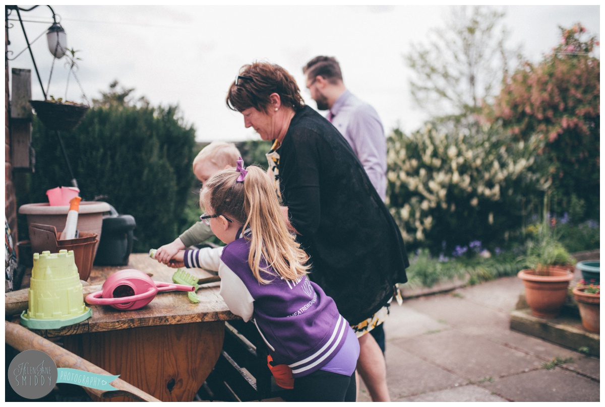 Isla and Arthur hunt for chocolate with their grandparents in the garden.