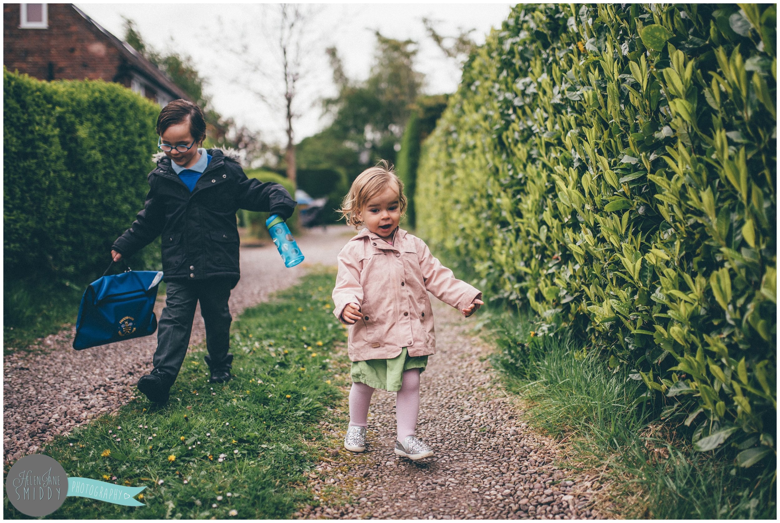 Brother and sister walking to school during A Day In The Life photoshoot in Frodsham, Cheshire.