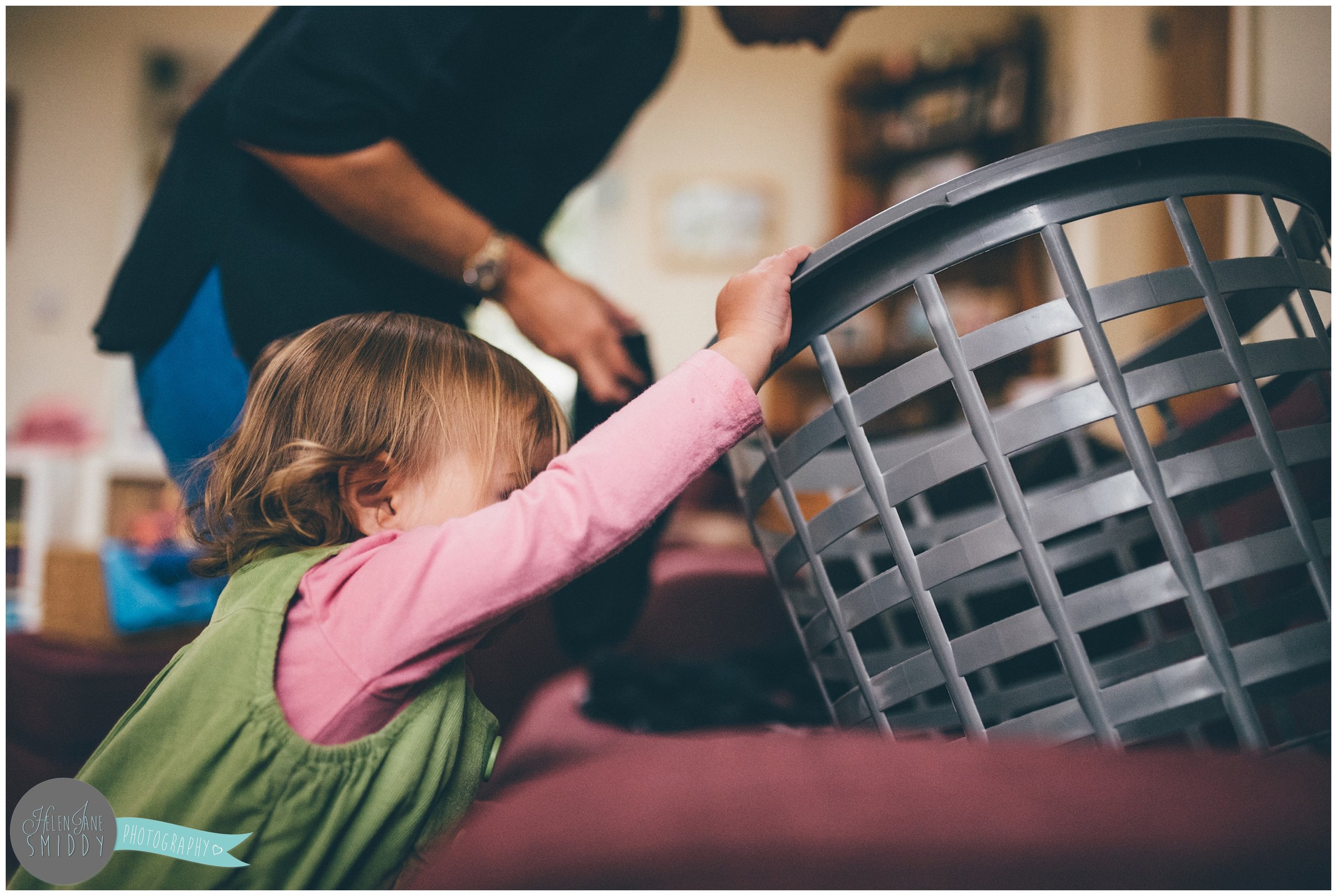 Helping Mummy with laundry during A Day In The Life photoshoot in Frodsham, Cheshire.