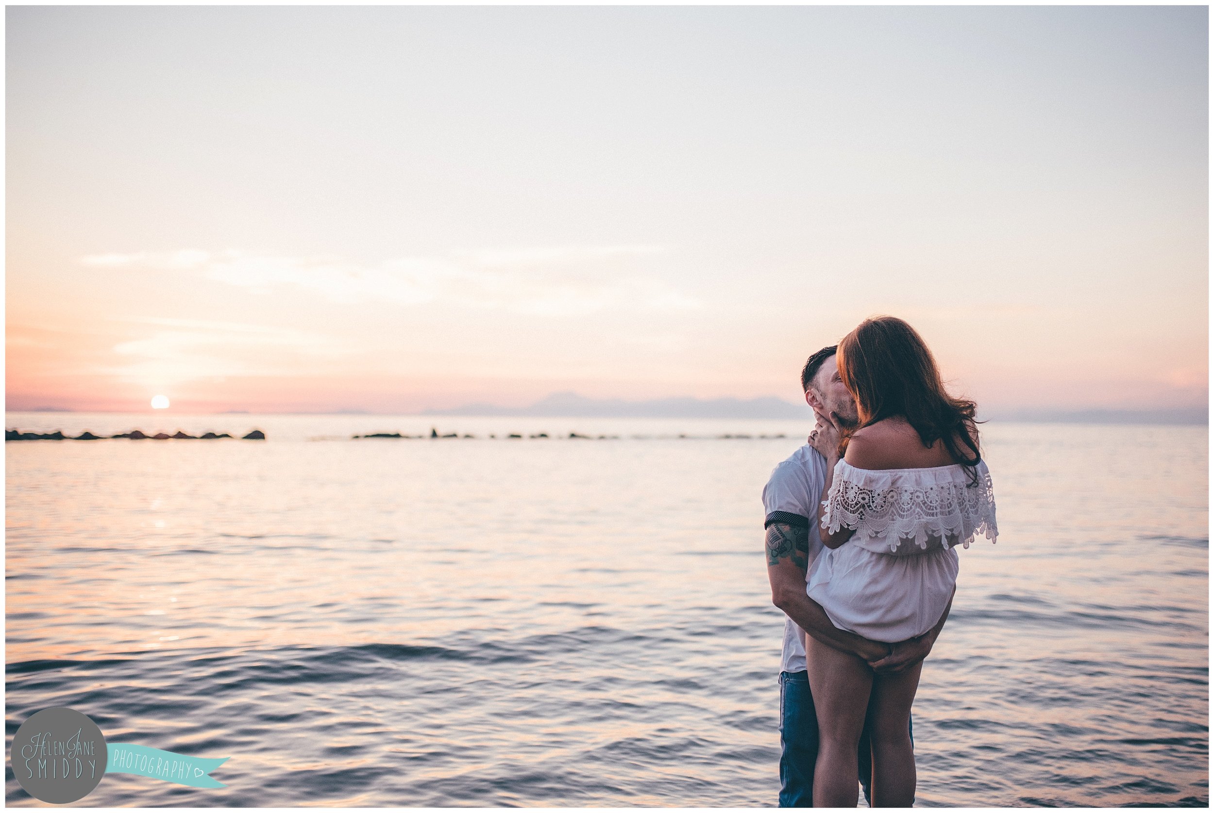 Sabrina and Dom kiss on the beach at sunset in Santa Maria di Castellabate for their pre-wedding photoshoot.