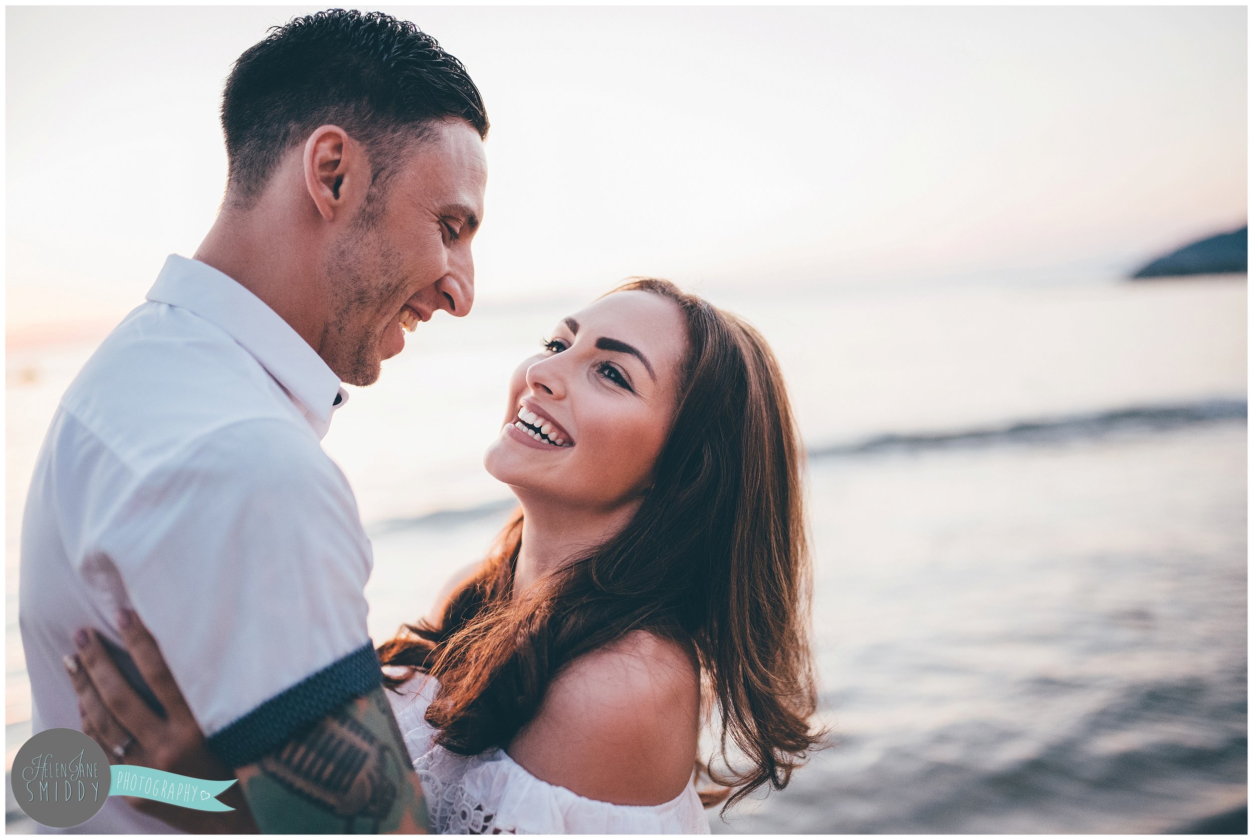 The beautiful couple the dy before their wedding on the beach at sunset.