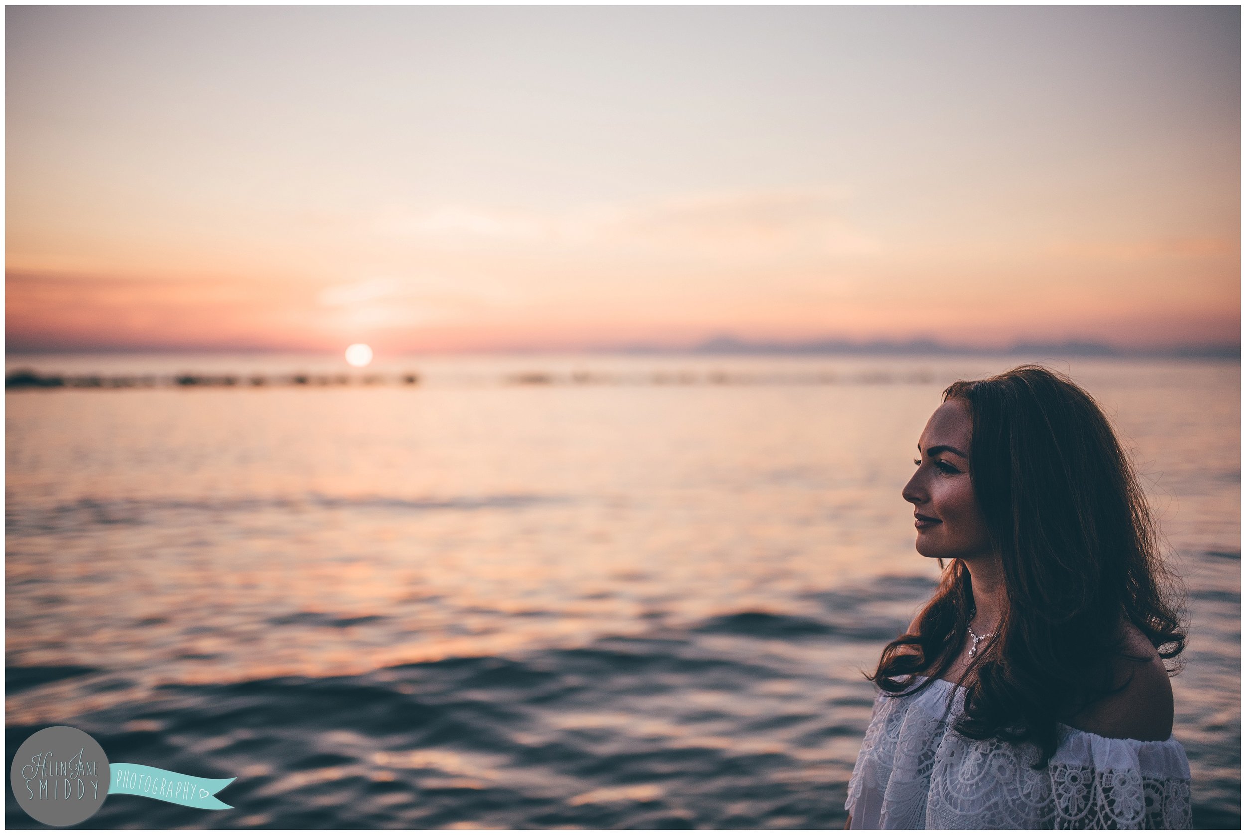 The stunning bride-to-be watches the sun set.
