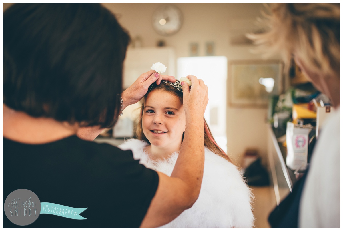 Cheshire wedding photographer captures flower girl getting ready at Barn Drift in Norfolk.