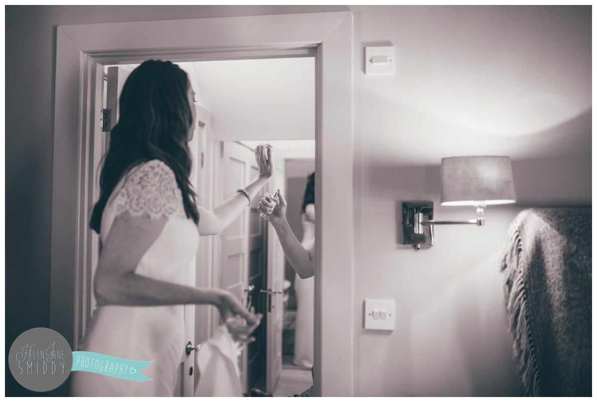 Bridesmaid sprays Jo Malone perfume on the bride once she's ready.