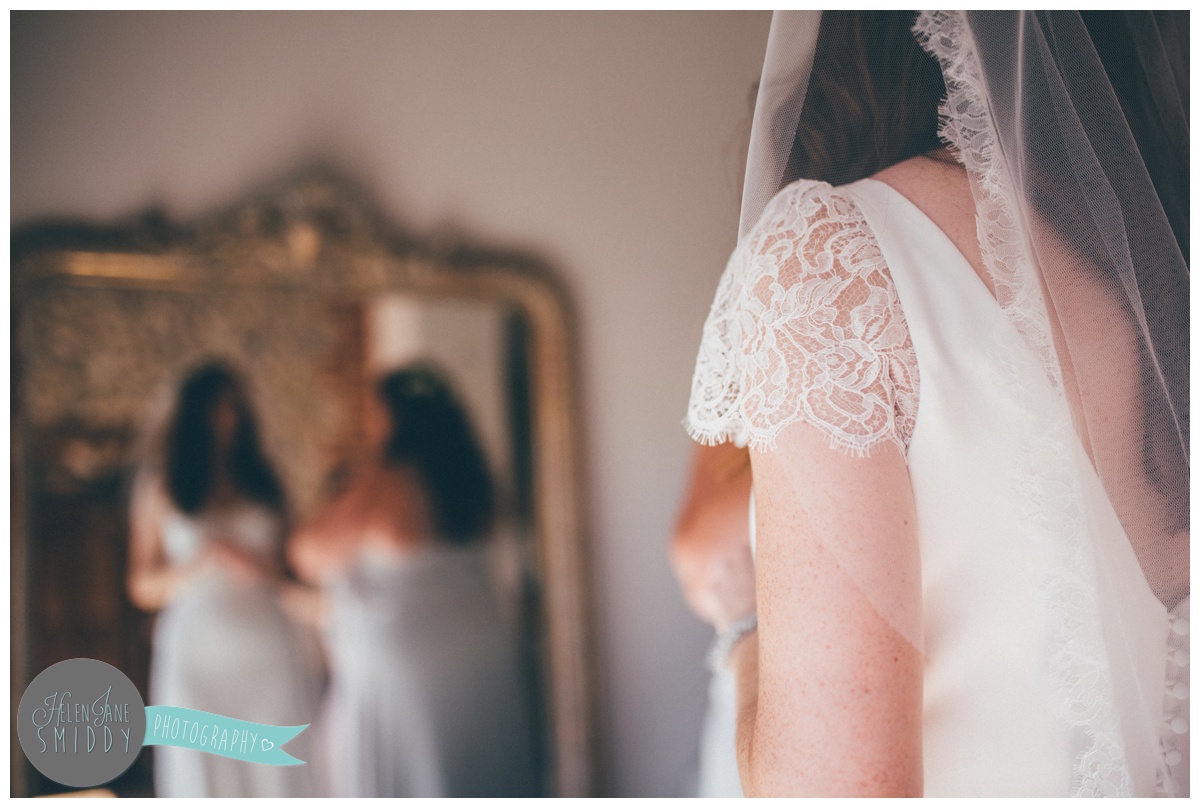 The lace detail of the beautiful wedding gown.