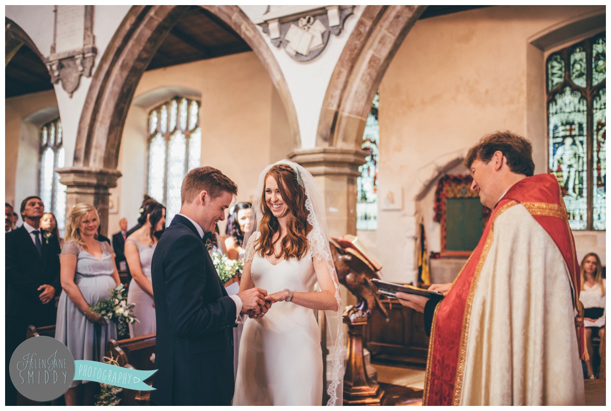 Cheshire wedding photographer shoots wedding in Norfolk, the couple exchange rings in church.