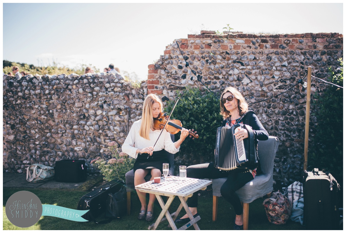 Guests enjoying the sun at a beautiful September wedding at Barn Drift in Norfolk.