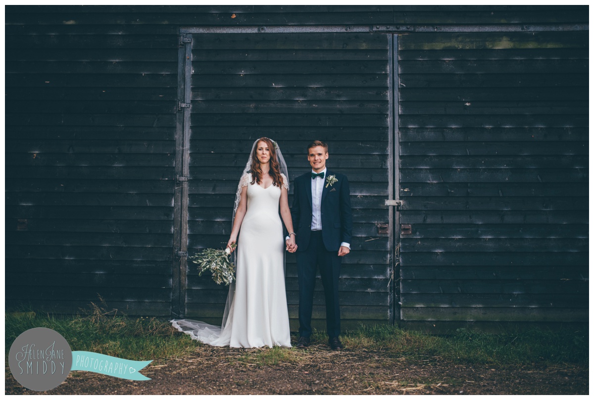 Bride and Groom pose at their beautiful September wedding at Barn Drift in Norfolk.