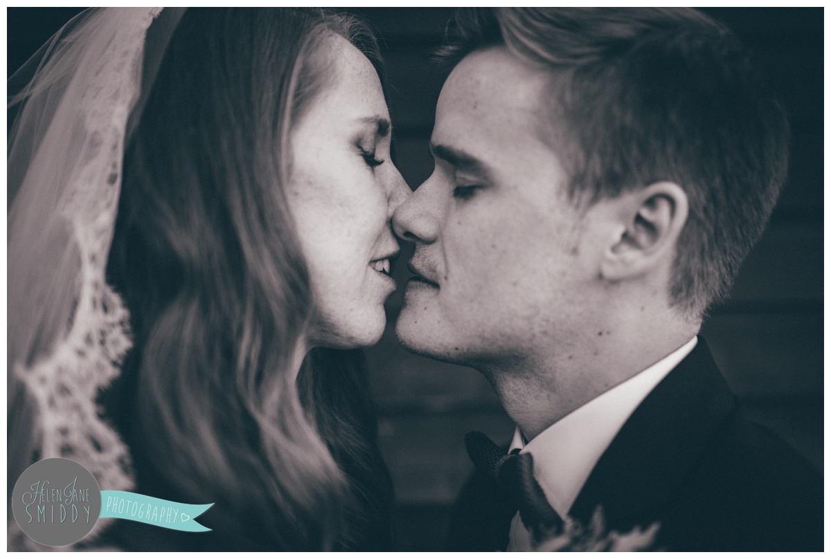 Bride and Groom kiss at their beautiful September wedding at Barn Drift in Norfolk.