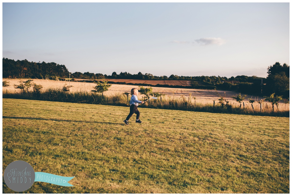 Cheshire wedding photographer captures cute little page boy playing at a wedding.