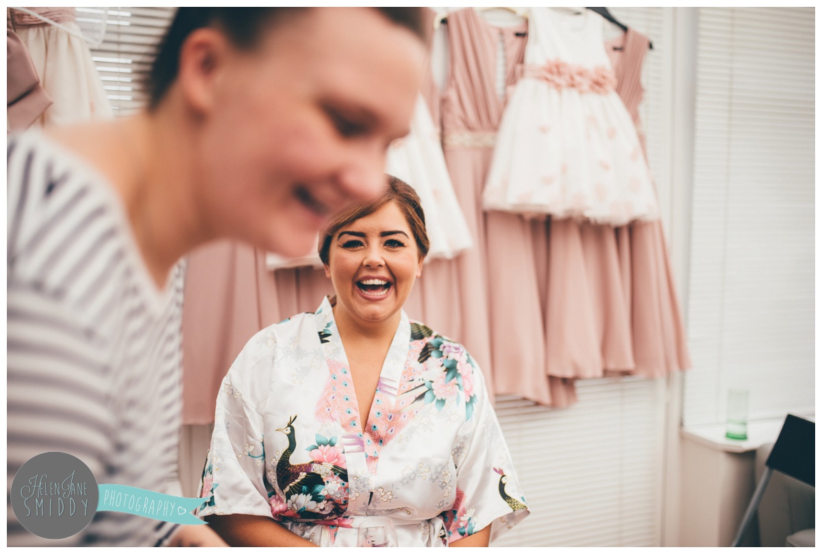 Bride, Hannah, shares a joke with her make-up artist.