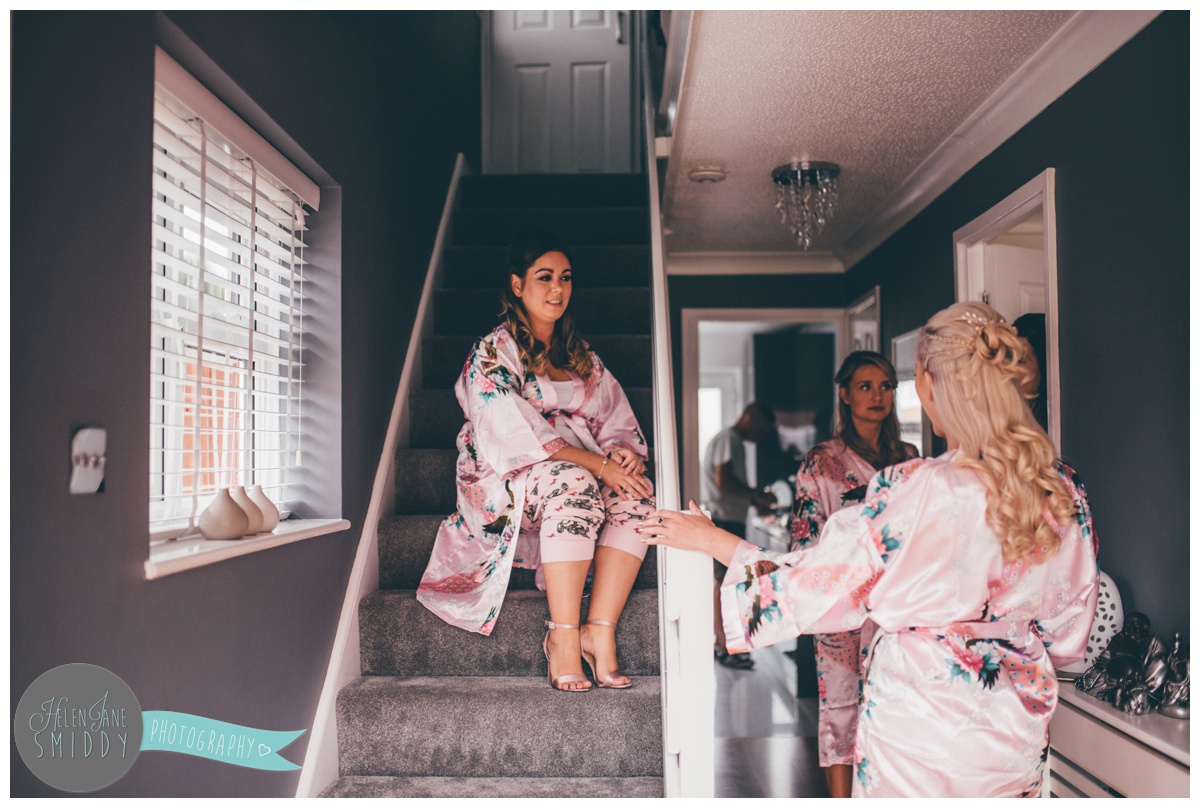 The bridal party gather in their matching dressing gowns.