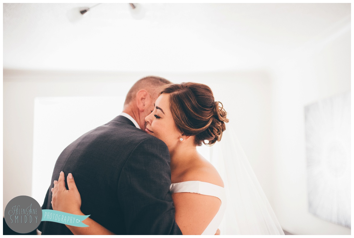 father of the bride sees his daughter in her wedding dress for the first time.