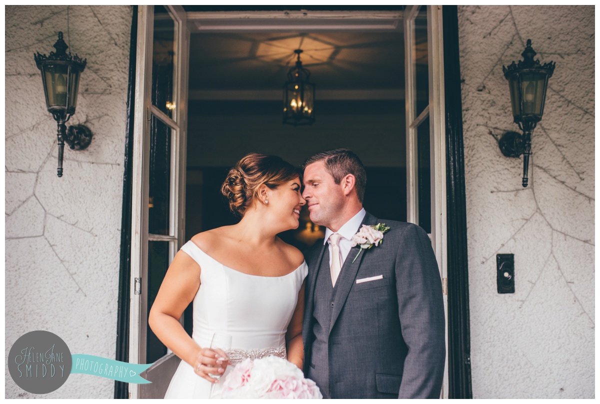 The bride and groom share a private moment at their wedding venue.