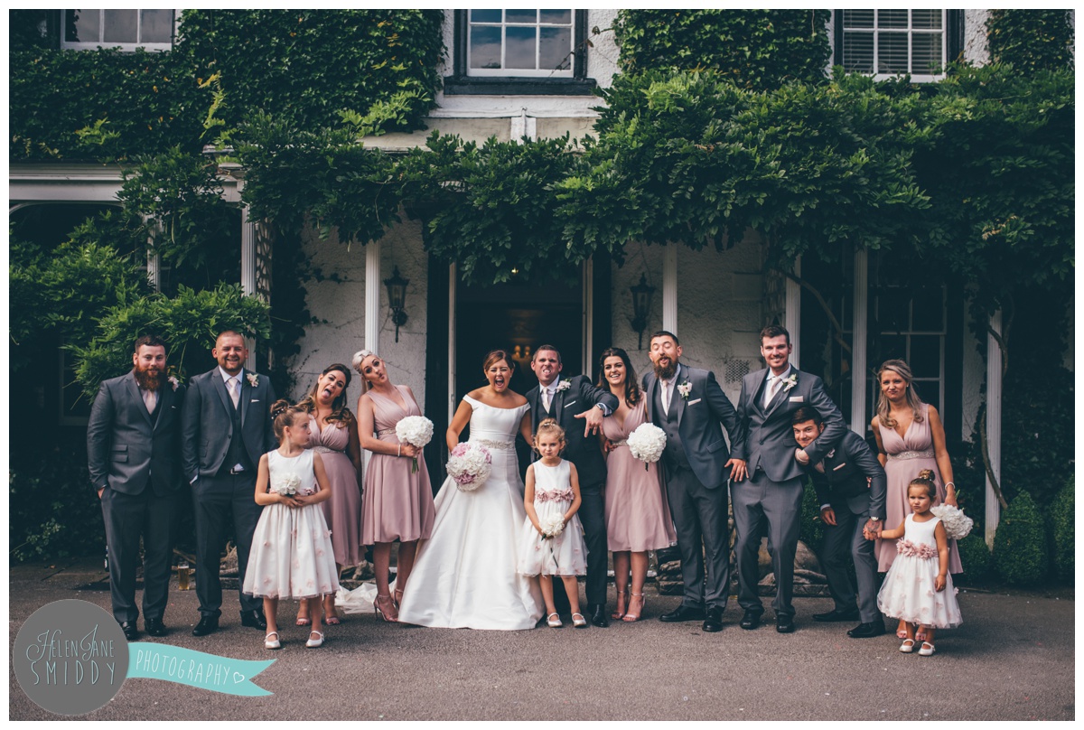The ful wedding party outside the porch of Statham Lodge in Cheshire.