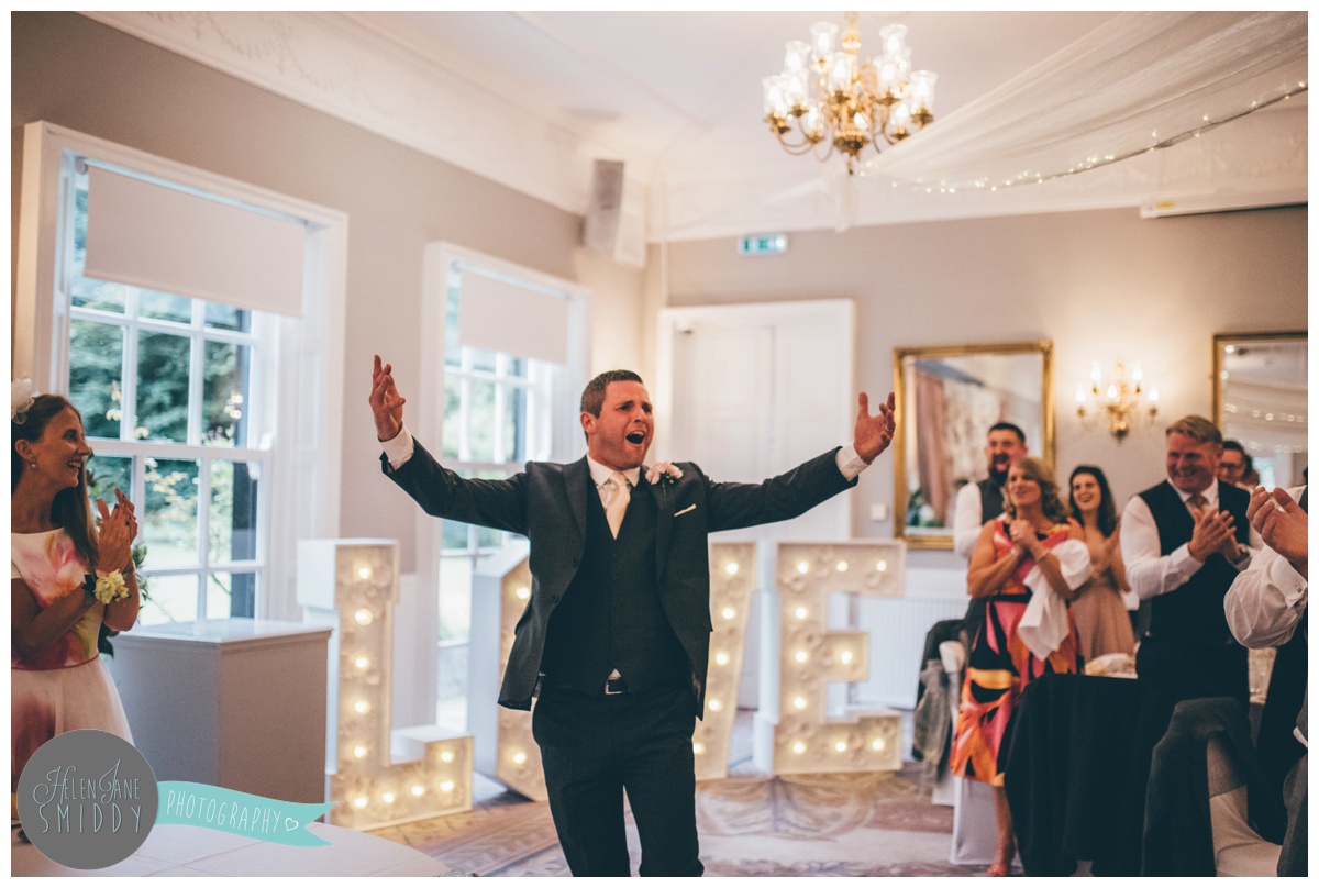 The groom celebrates with his wedding guests at Statham Lodge.
