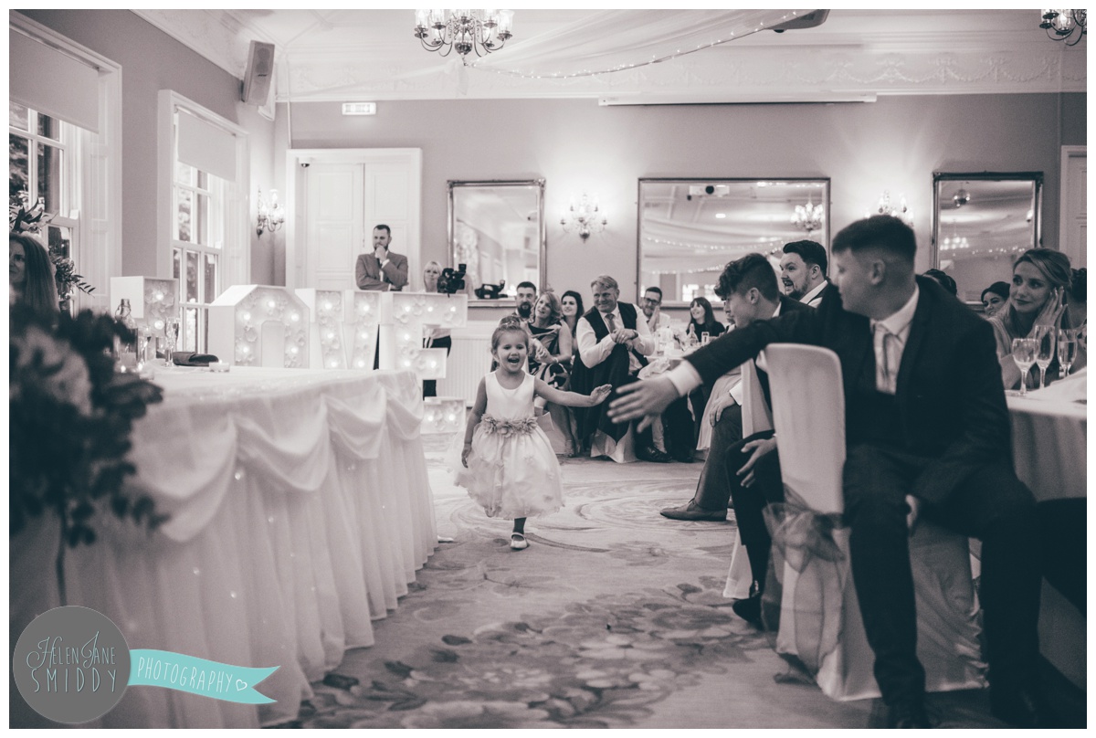 Flower girl runs around whilst the wedding guests listen to the speeches.