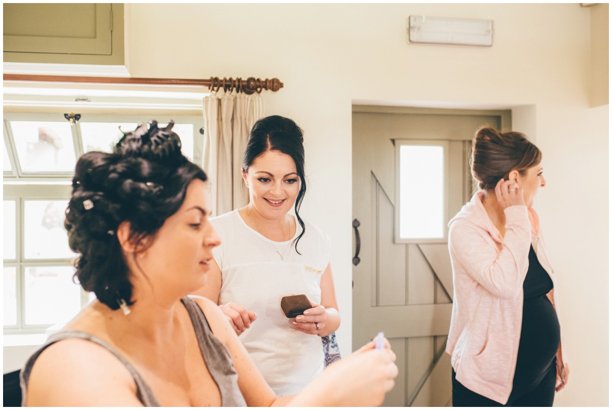 The bridsmaids joke with the bride before her wedding at The Ashes wedding barn in Staffordshire.