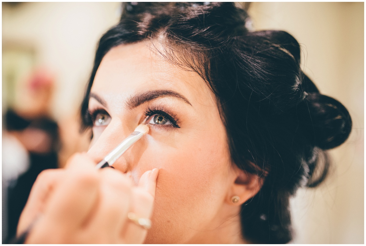 The beautiful bride getting her make-up done on the morning of her wedding at The Ashes wedding barn in Staffordshire.