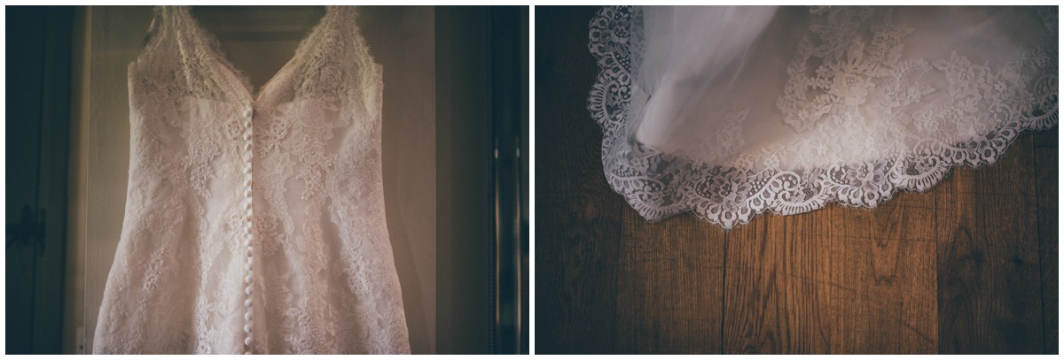 The pretty lace wedding gown hung up in the bridal suite at The Ashes wedding barn in Staffordshire.
