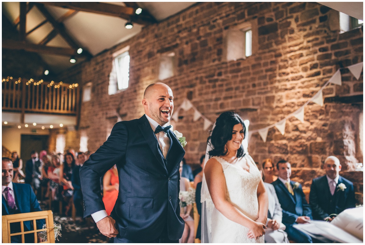 The bride and groom take their vows at The Ashes wedding barn in Staffordshire.