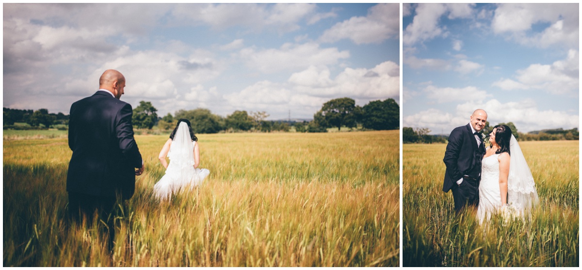 The newyleds walk through cornfields for their wedding portraits at The Ashes wedding barn in Staffordshire.