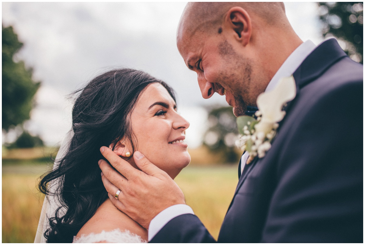 Phil strokes his new wife's cheek at The Ashes wedding barn in Staffordshire.