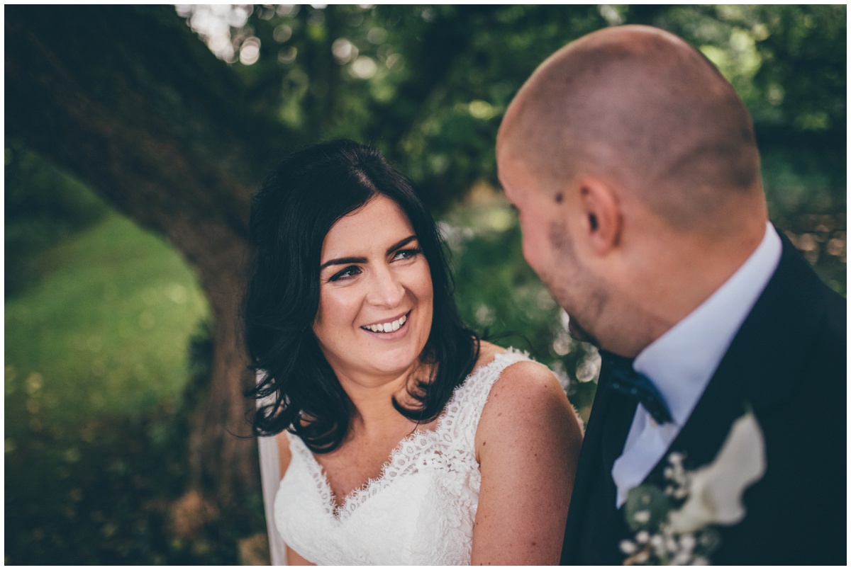 The bride laughs with her new husband at The Ashes wedding barn in Staffordshire.