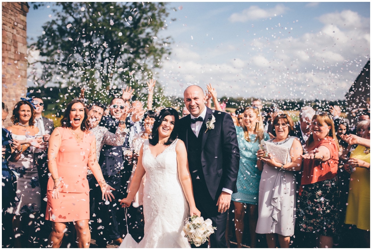 Beautiful sunny confetti photograph at The Ashes wedding barn in Staffordshire.