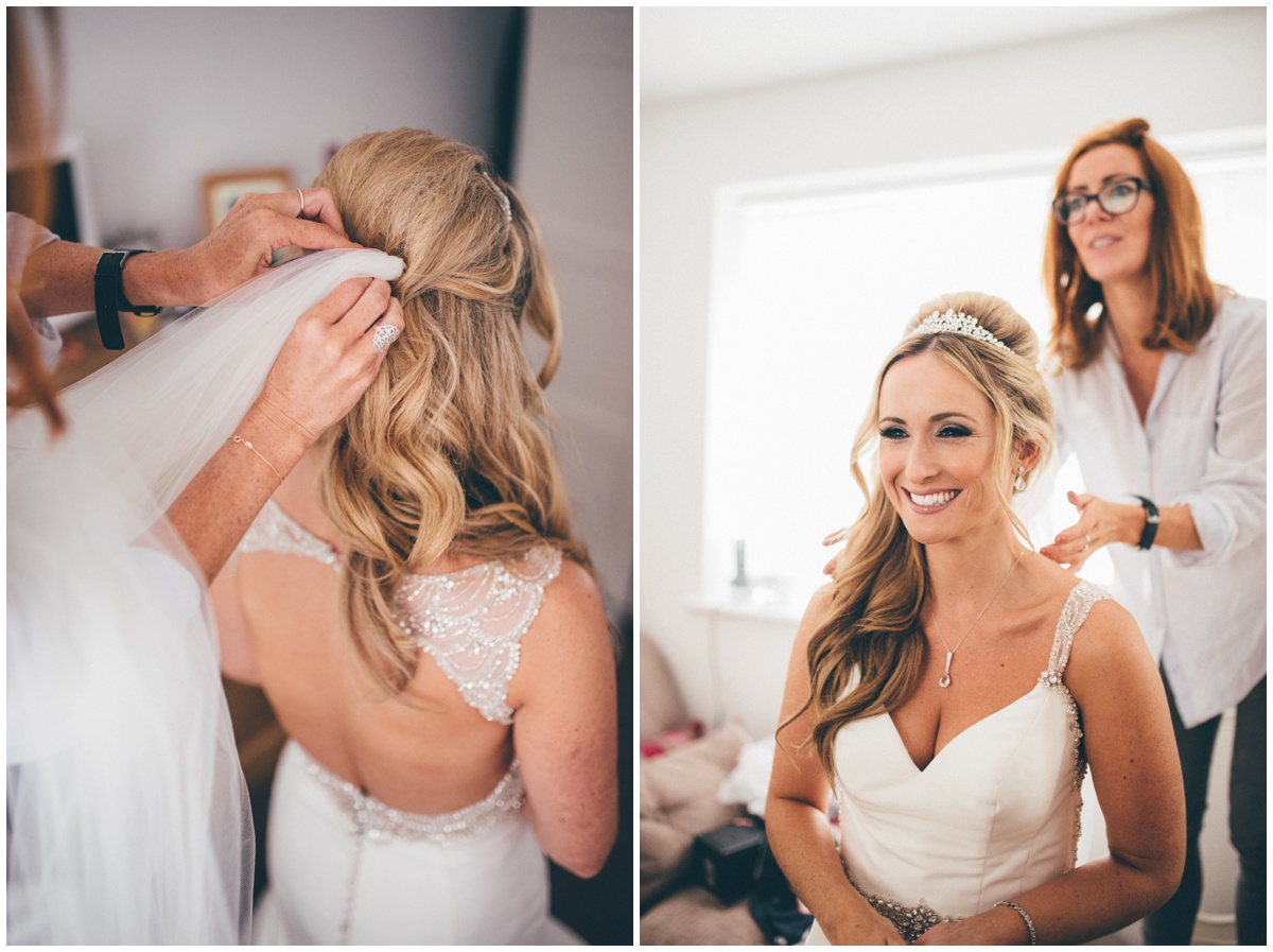 The make-up artist puts the bride's veil in before the ceremony.