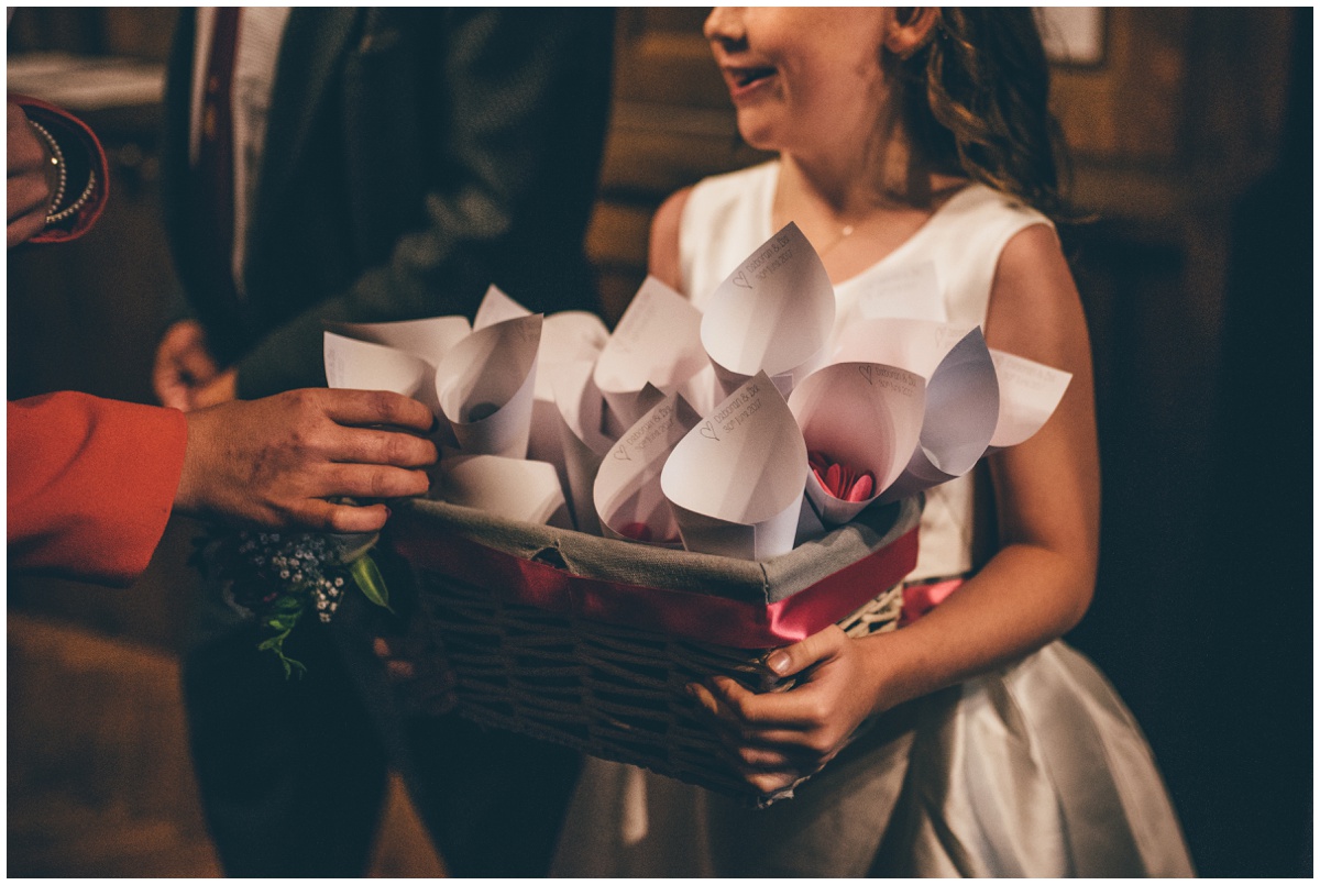 The flowergirl hands out confetti to the wedding guests at St Mark's Church in Worsley.