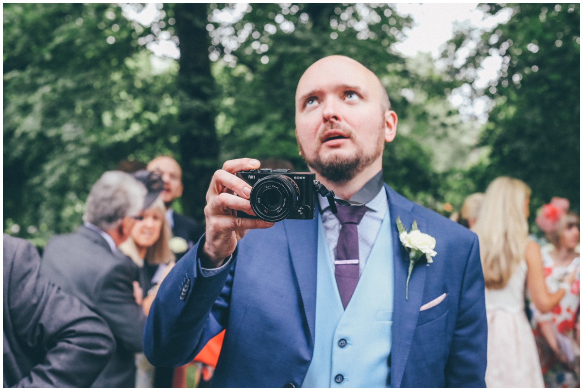 Manchester photographer rolls his eyes as the wedding photographer tries to take his photograph.