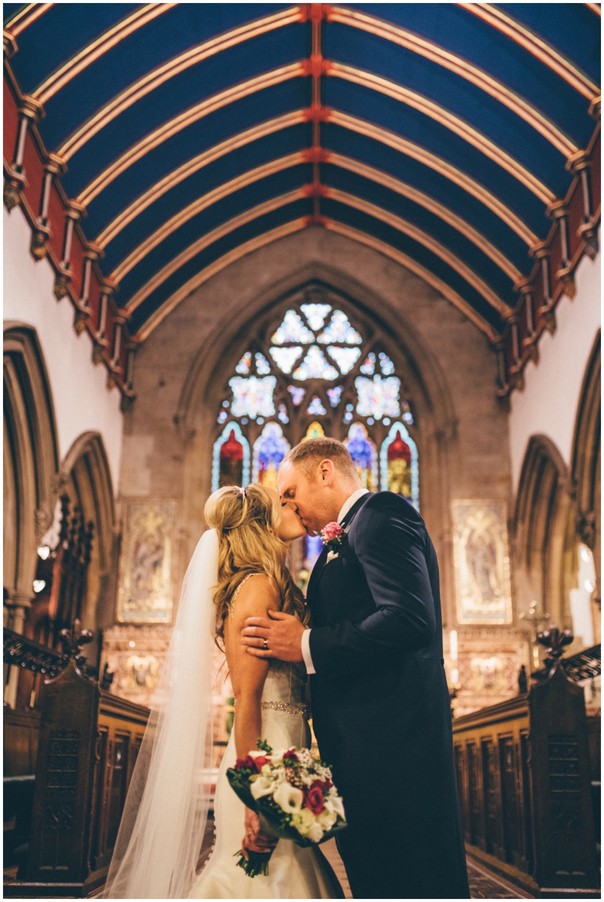 New husband and wife share their First Kiss at St Mark's Church in Worsley.