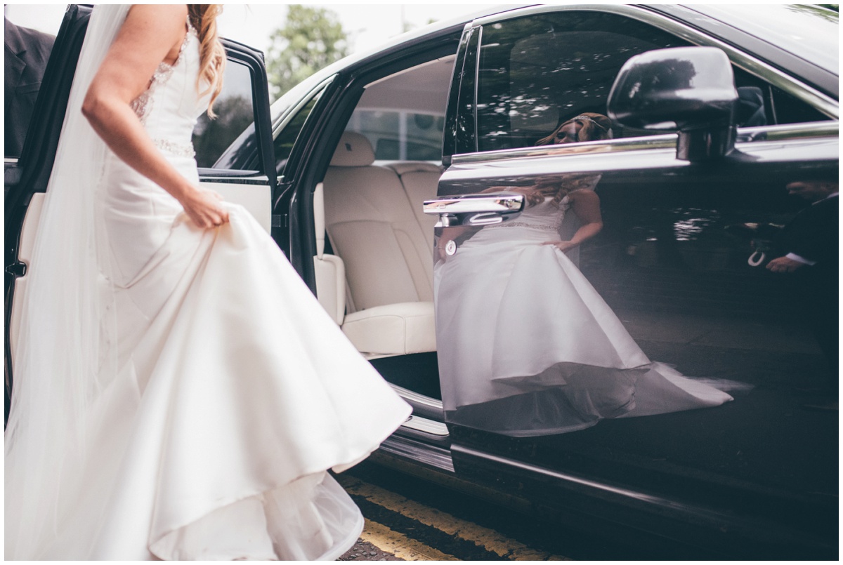 The bride's beautiful reflection in her wedding car outside their wedding venue at Willington Hall in Cheshire.